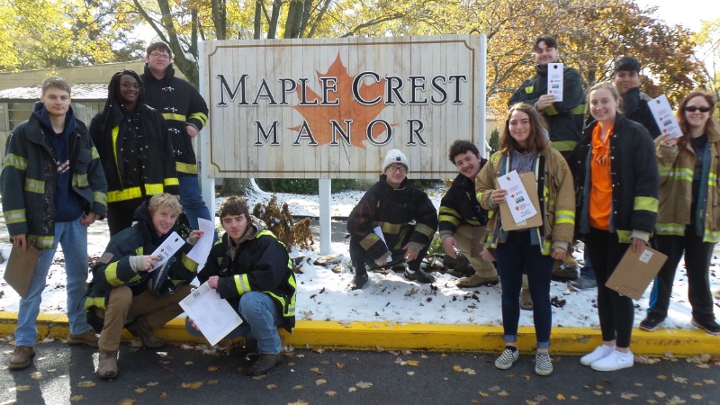 Fire-Rescue-EMR Students surrounding Manor Care Sign